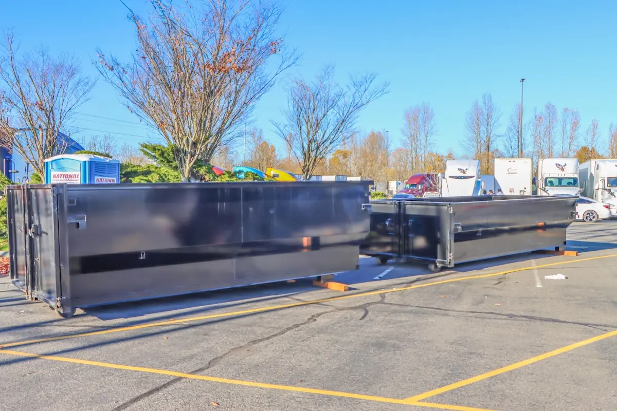 Professional dumpster rental service with roll-off container on residential driveway in Rothschild